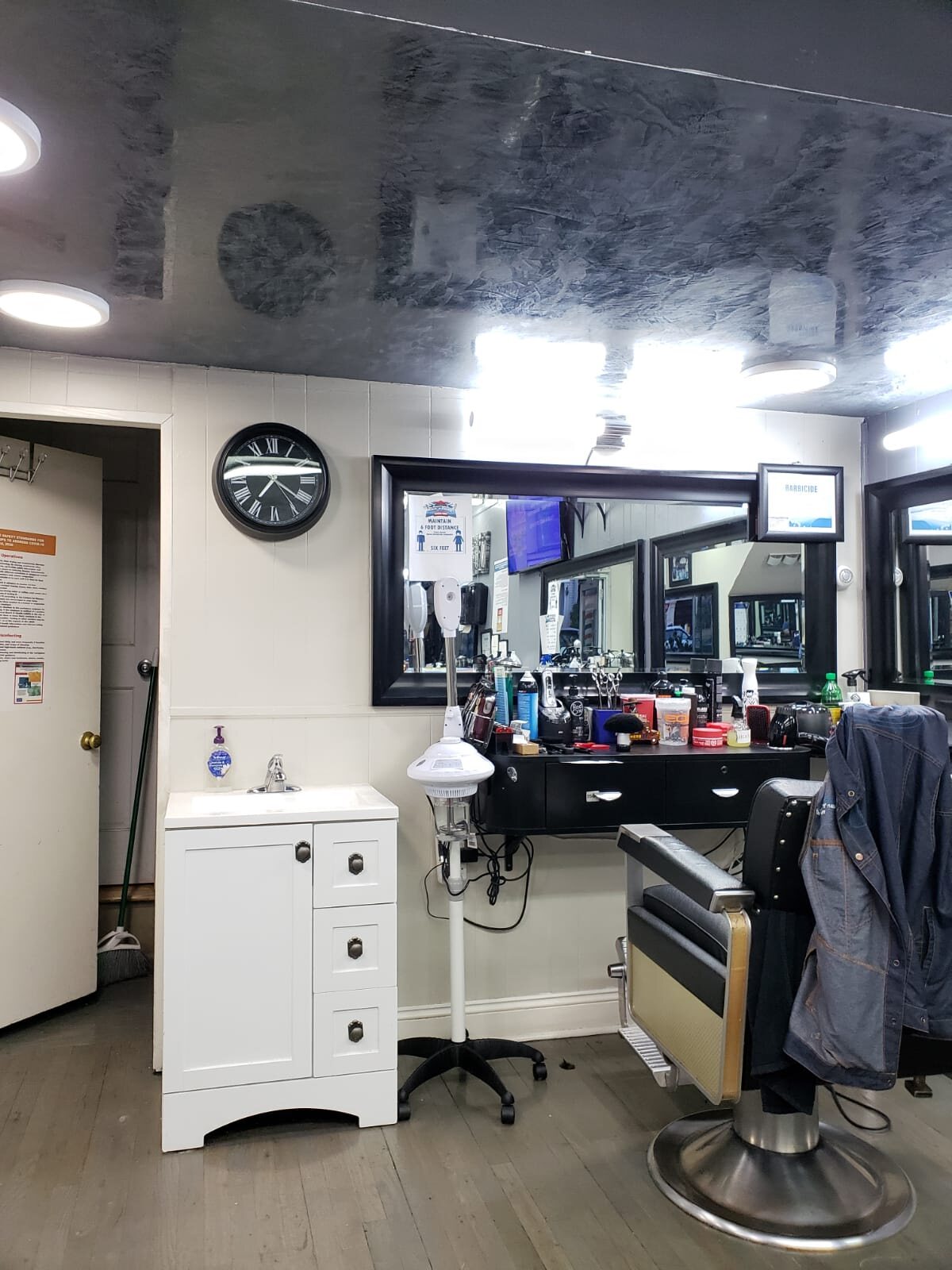 Custom dark decorative plaster ceiling in a barbershop